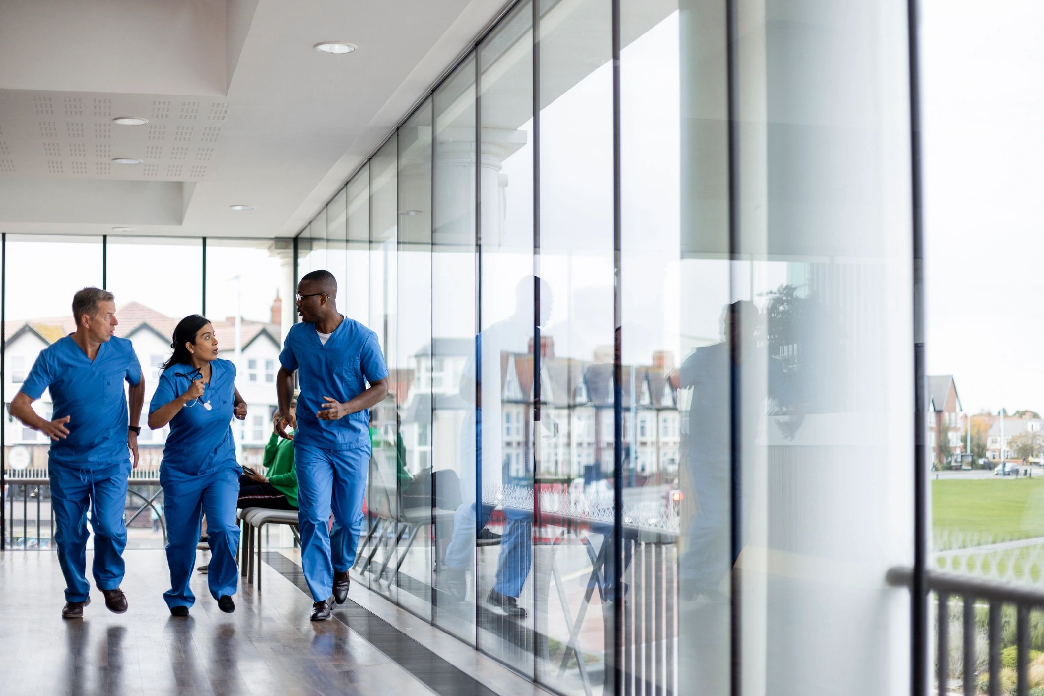 Healthcare professionals moving through a hospital corridor