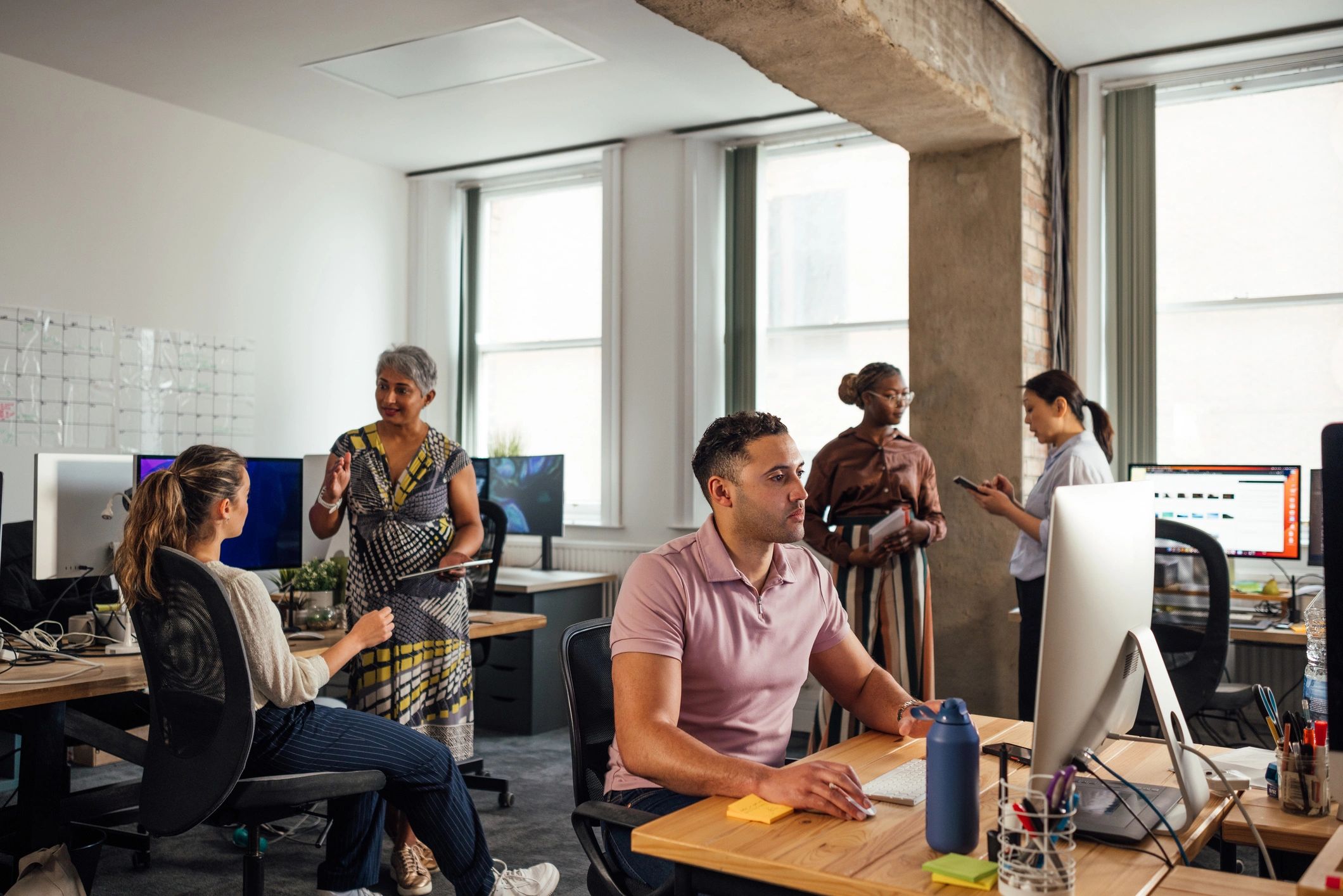 CyberFactory professionals collaborating in an office environment
