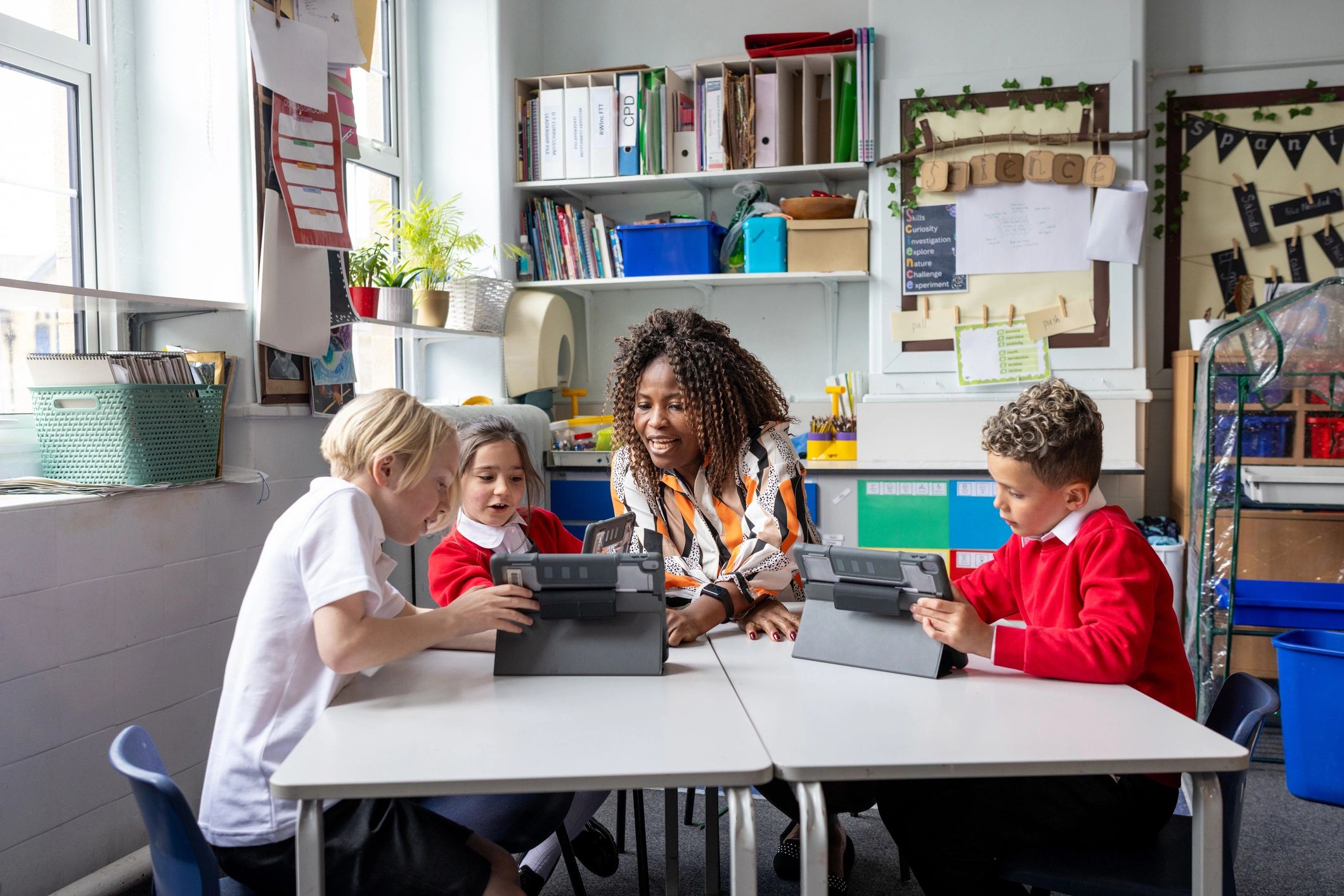 Students and teacher using digital tablets in a smart classroom