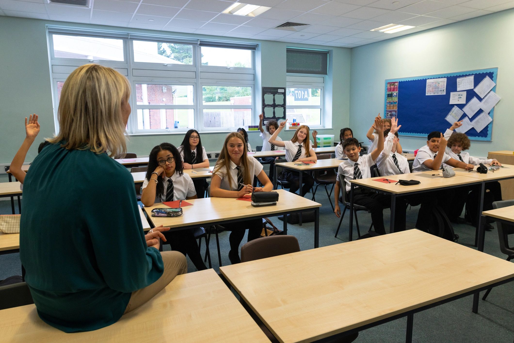 Modern classroom with teacher and students using technology