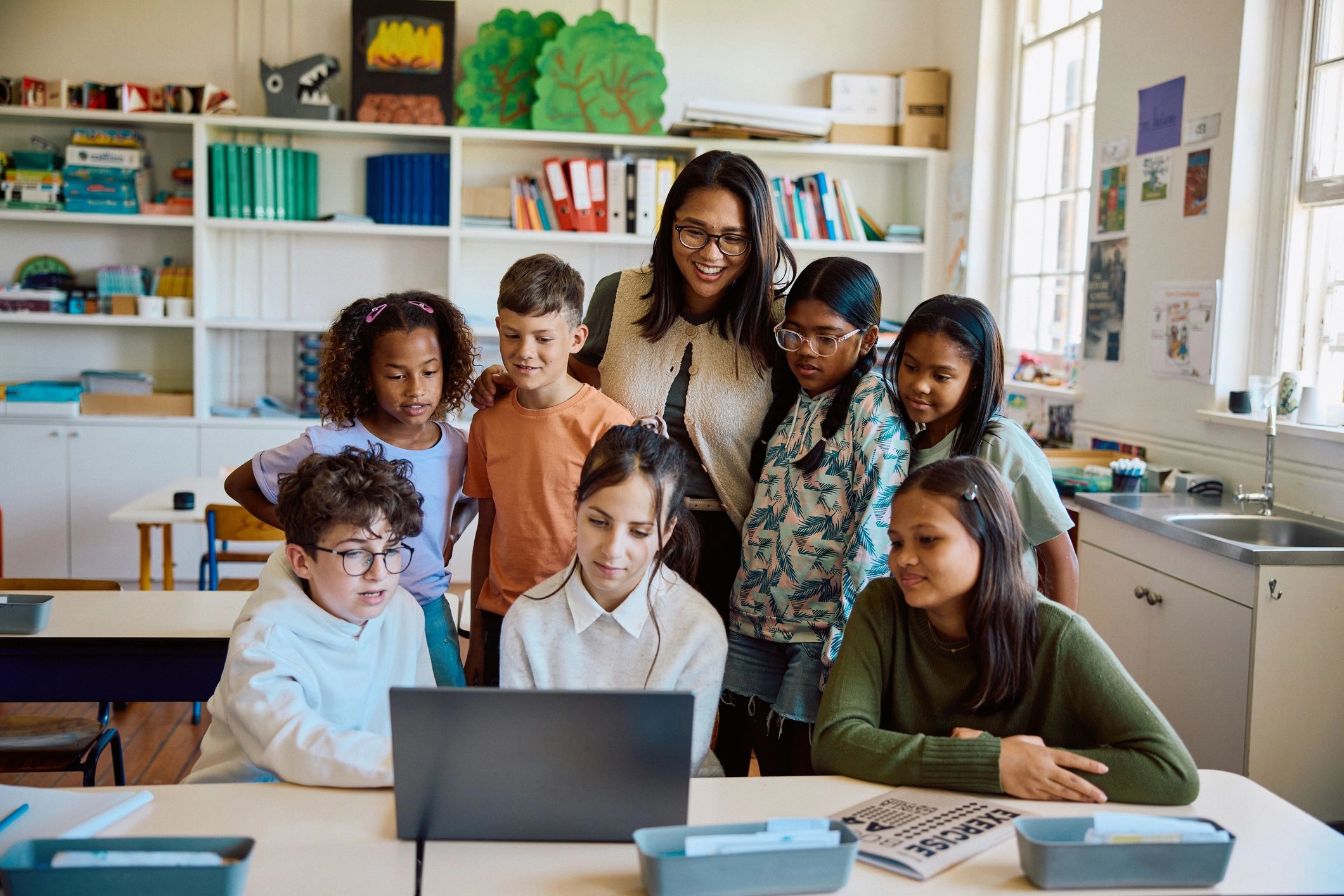 Students and teacher using digital learning technology in a classroom