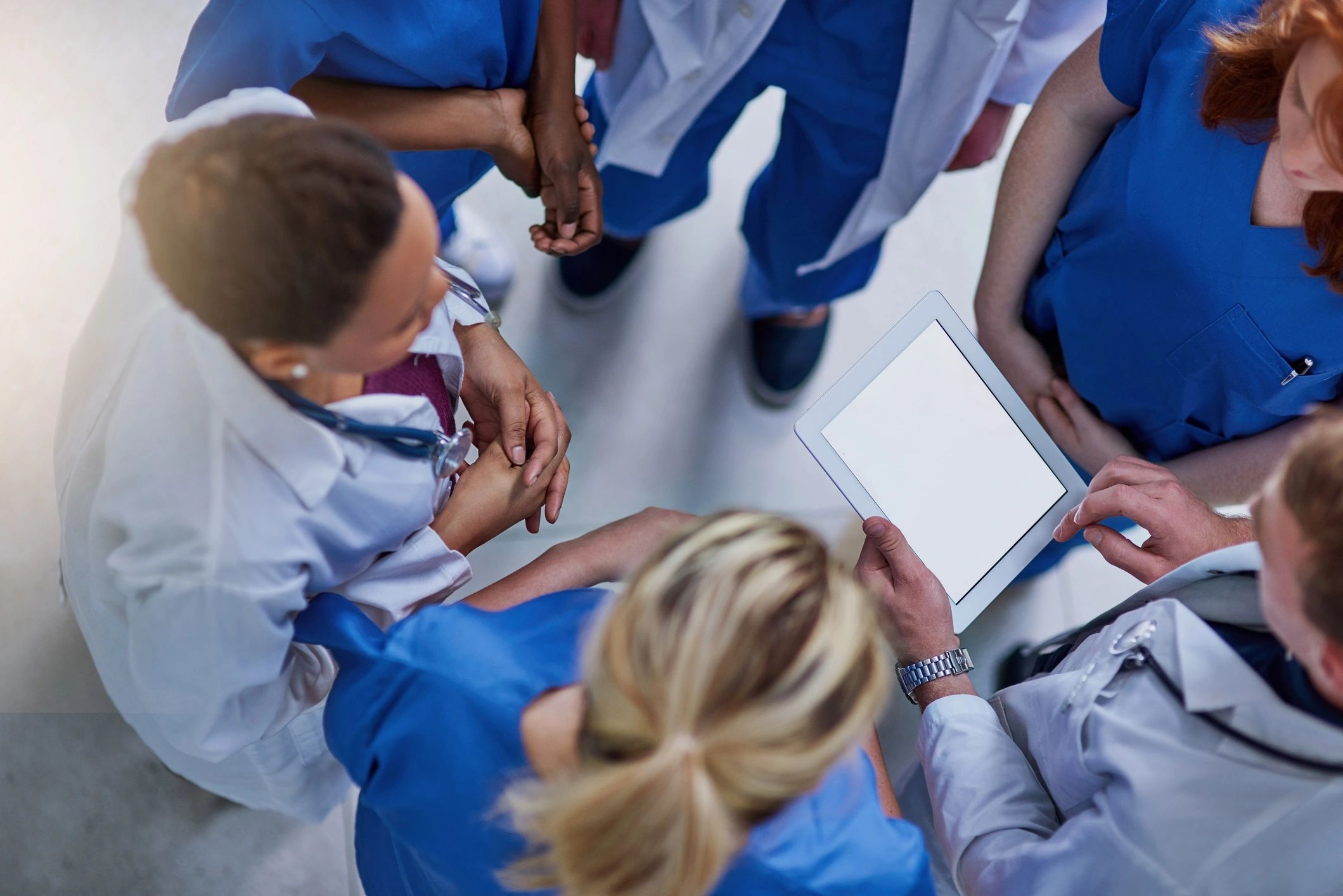 Medical professionals collaborating with digital technology